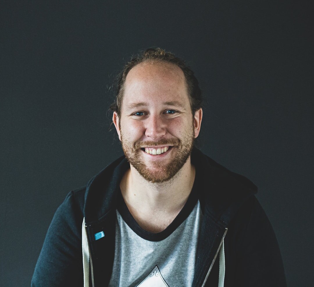 Young professional Belgian man smiling