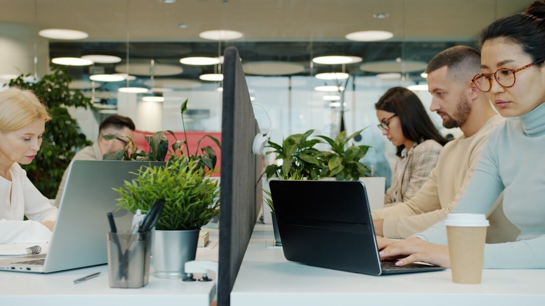 Diverse startup team collaborating at computers in a modern office