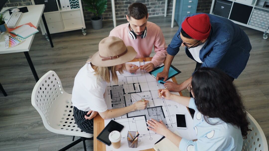 Media team planning a communications campaign around a table